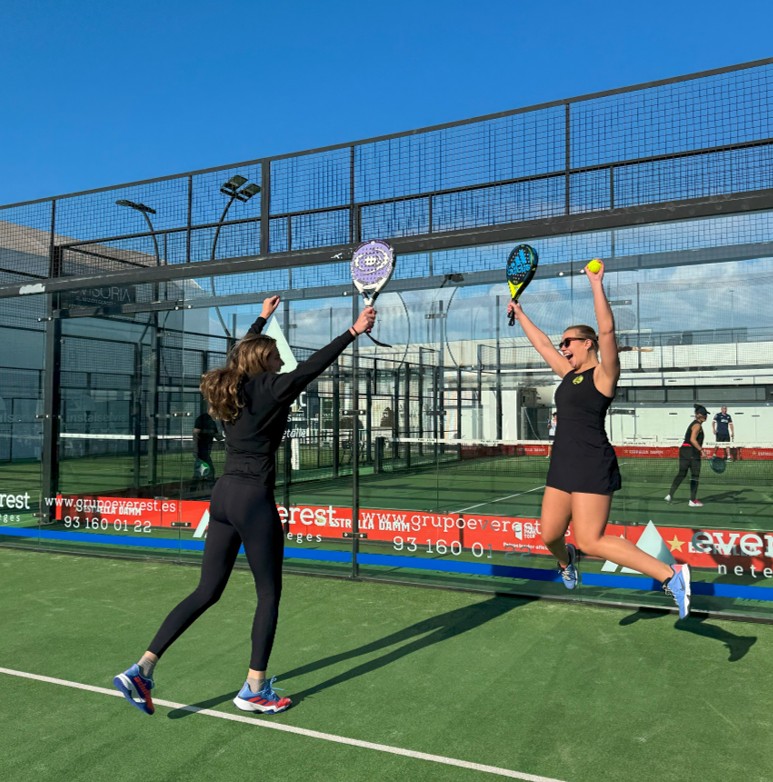 Women celebrating after playing padel on court - padel holiday Spain group experience